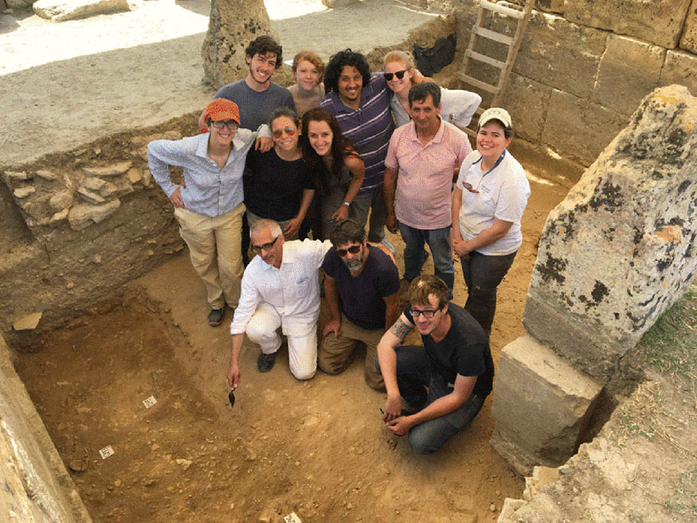 Group photos of archaeologists in a trench.