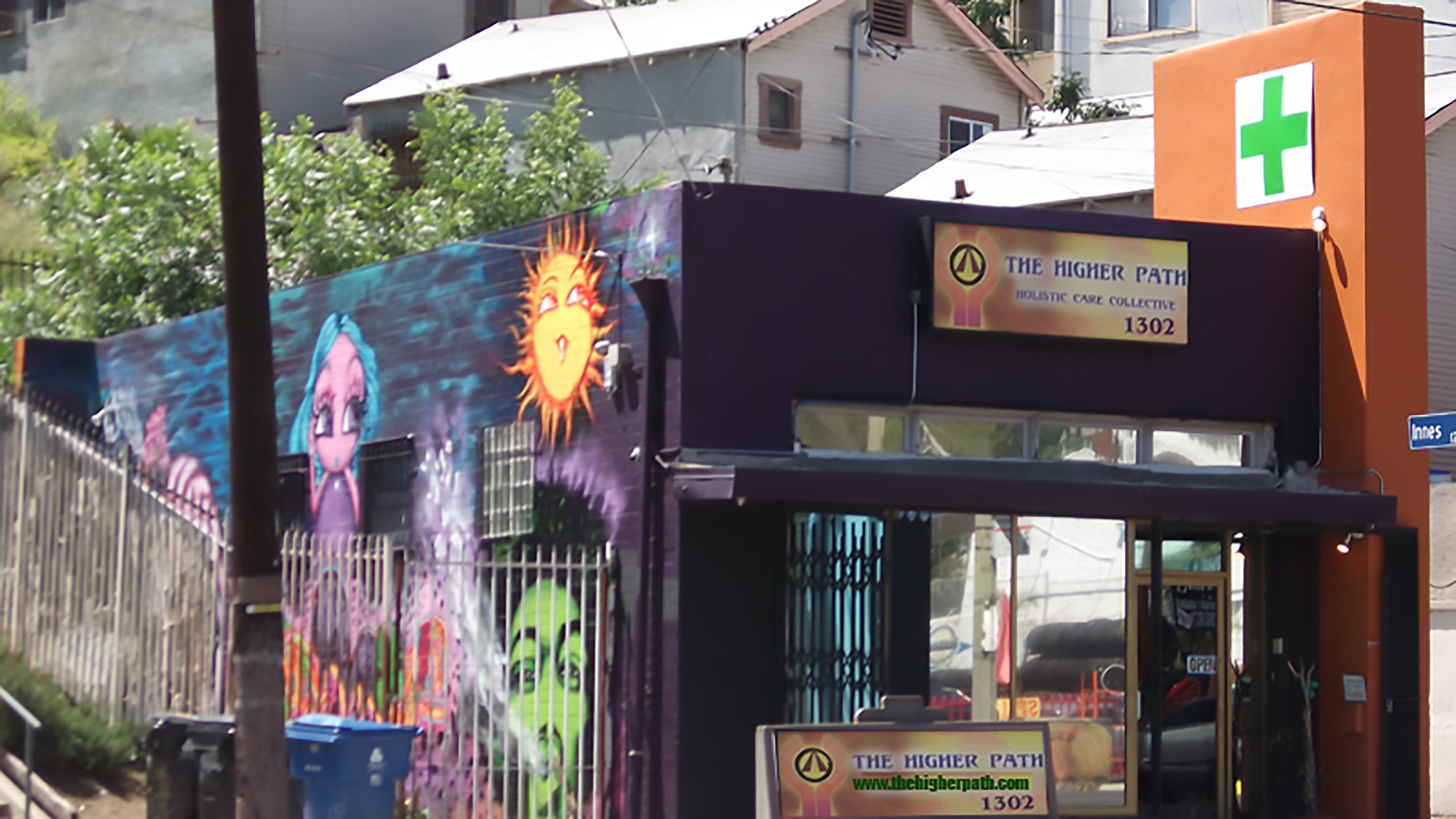 A low resolution view of the Higher Path Holistic Care Collective storefront in Echo Park, Los Angeles. The mural by Timoi is visible on the side of the building.