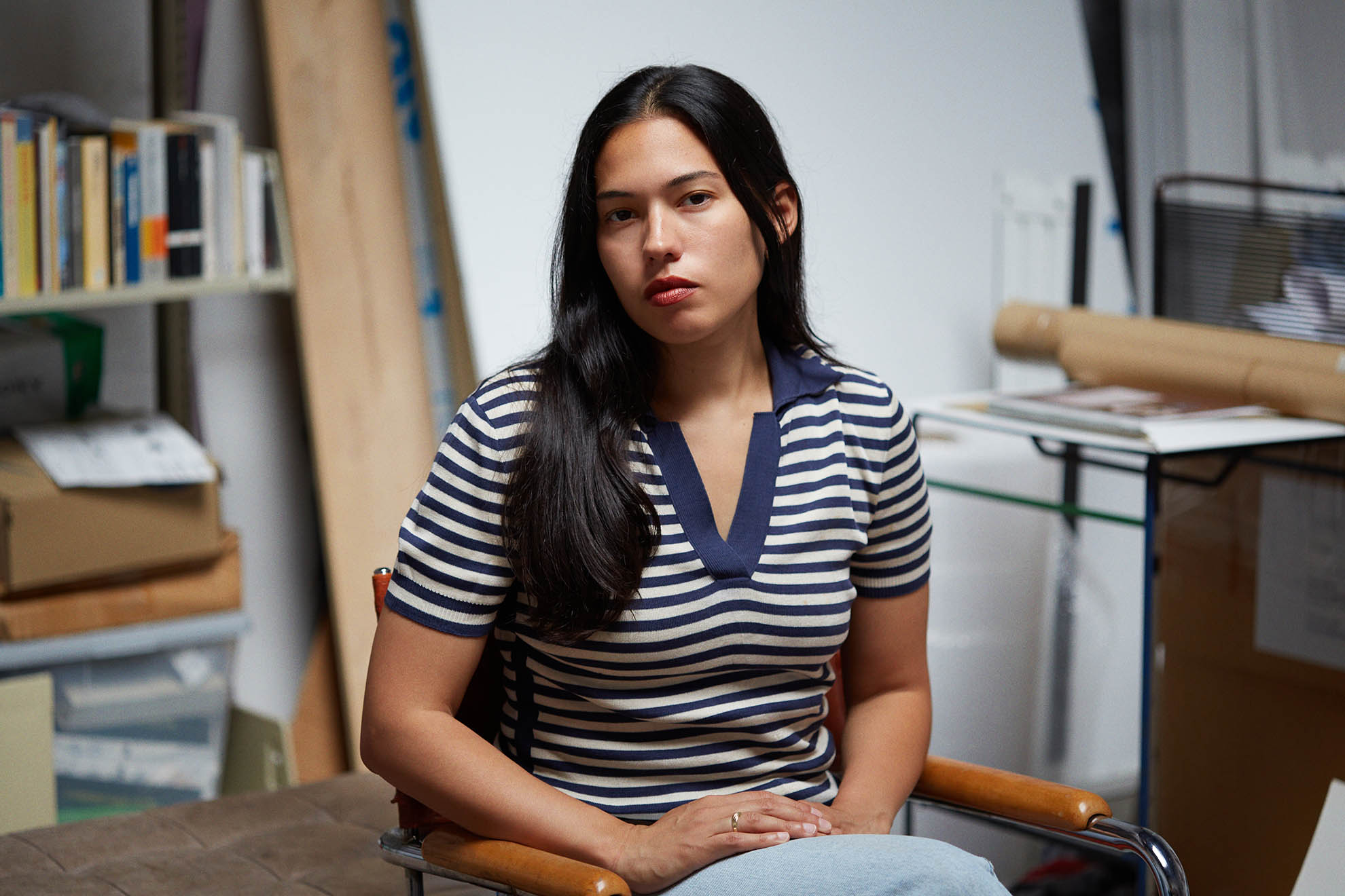 Portait of the artist in front of her work.