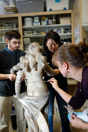 Students in the Conservation Center lab working on a marble sculpture.