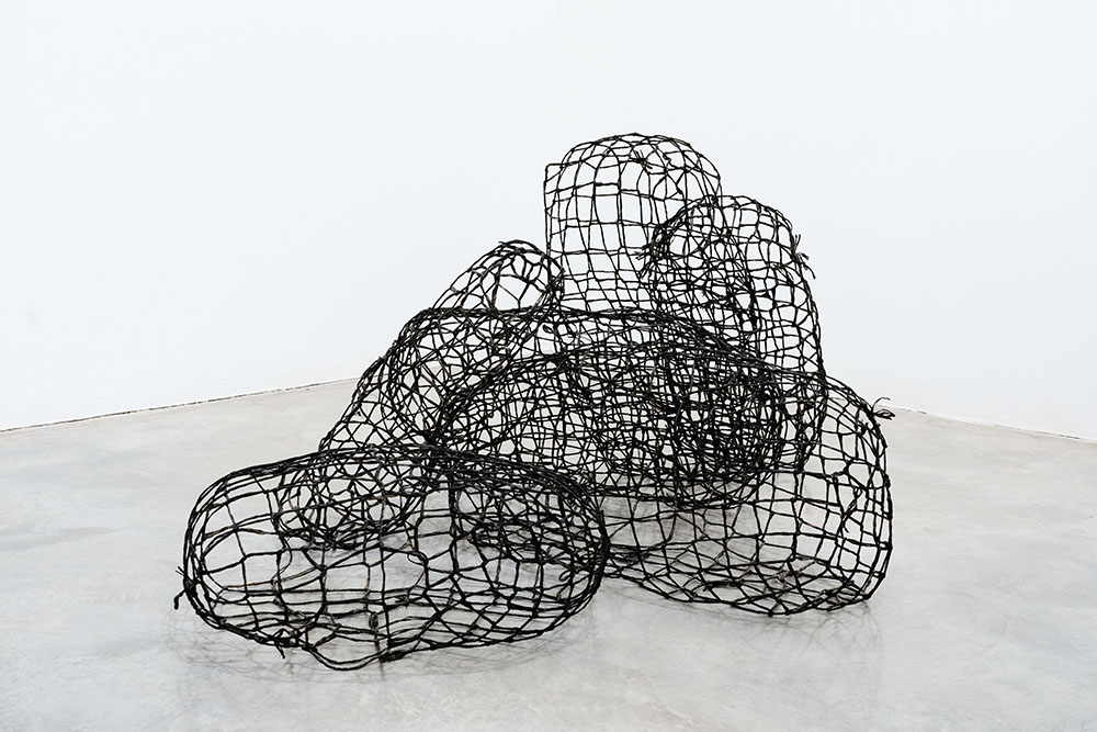 Sculptures that look like black rope wrapped around invisible objects